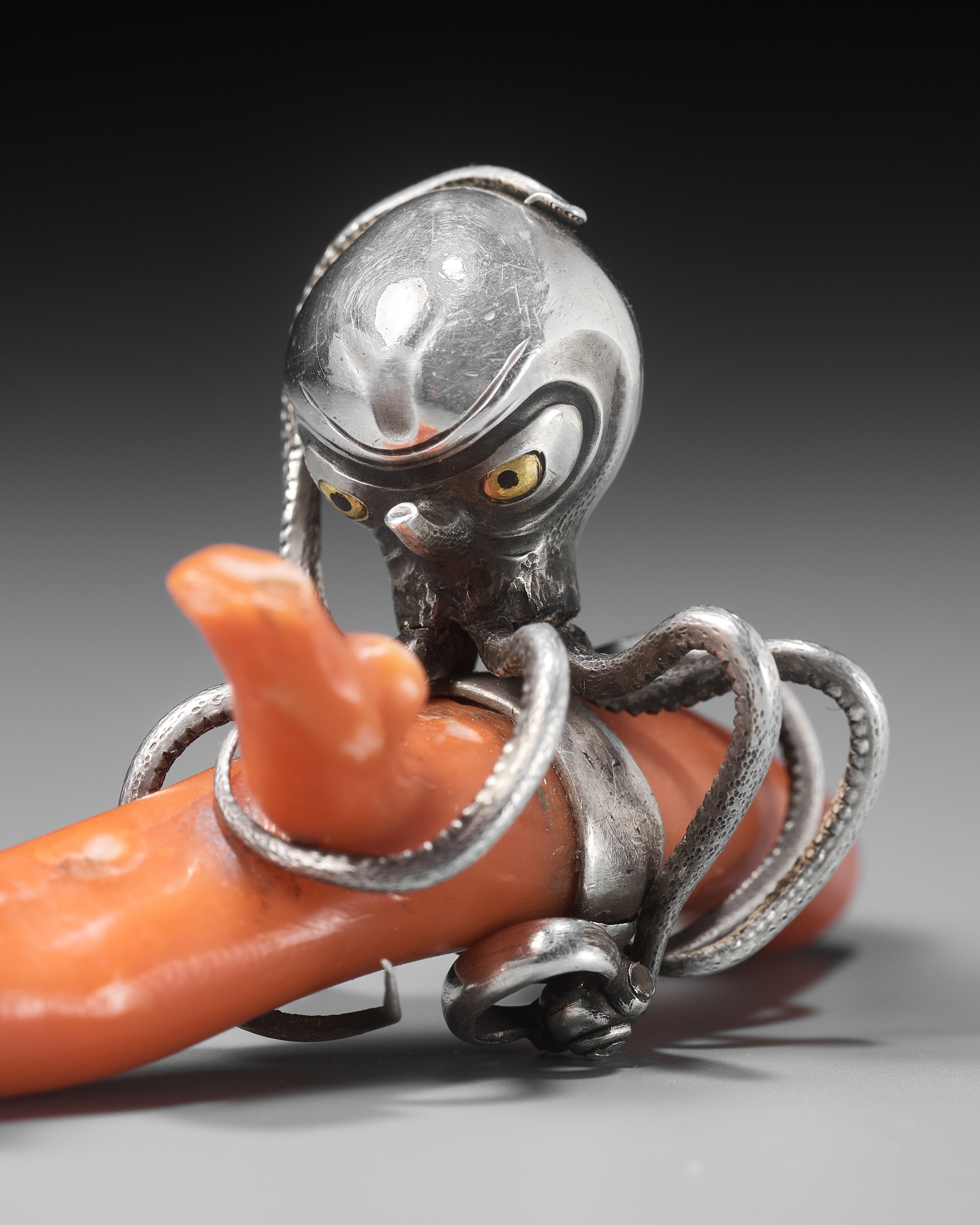 MINKOKU: A LARGE SILVER NETSUKE OF AN OCTOPUS GRASPING A PIECE OF CORAL