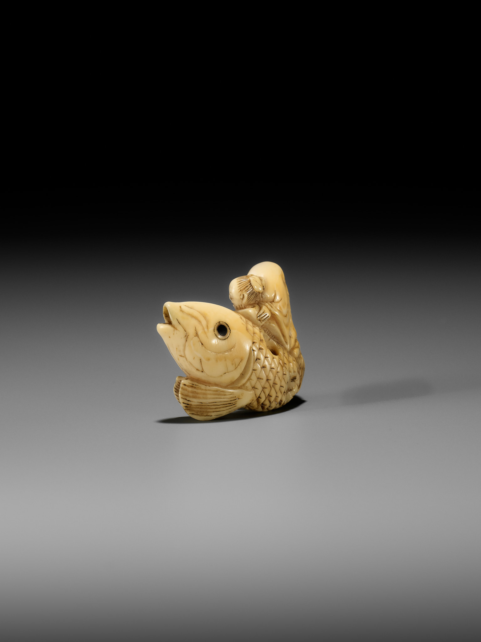 YOSHITSUGU: AN EARLY IVORY NETSUKE OF KINKO SENNIN ON A CARP - Image 11 of 14