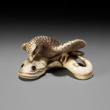 HIDEMASA: A FINE IVORY NETSUKE OF AN EAGLE AND NAMAZU