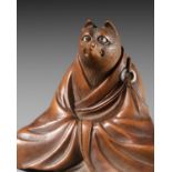 ANRAKU: A FINE AND HUMOROUS WOOD NETSUKE OF TANUKI DISGUISED AS A PRIEST