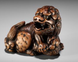 A FINE TANBA SCHOOL WOOD NETSUKE OF A SHISHI WITH YOUNG