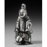 A VERY RARE SILVER NETSUKE OF A KEMARI PLAYER