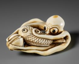 MASAKAZU: A LARGE AND IMPRESSIVE OSAKA SCHOOL IVORY NETSUKE OF AN OCTOPUS WITH CLAMS