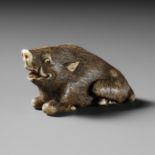 A KYOTO SCHOOL IVORY NETSUKE OF A FRIGHTENED RECLINING BOAR