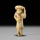 A RARE IVORY NETSUKE OF A DUTCHMAN AND MONKEY