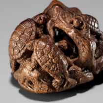 KAGETOSHI: A FINE KIRI (PAULOWNIA) WOOD NETSUKE OF TURTLES ON A ROCK