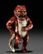 A RARE LACQUERED WOOD NETSUKE OF AN ONI TYING HIS FUNDOSHI