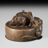 SHUZAN: A WOOD NETSUKE OF RATS ON A CHAUSU TEA MILL