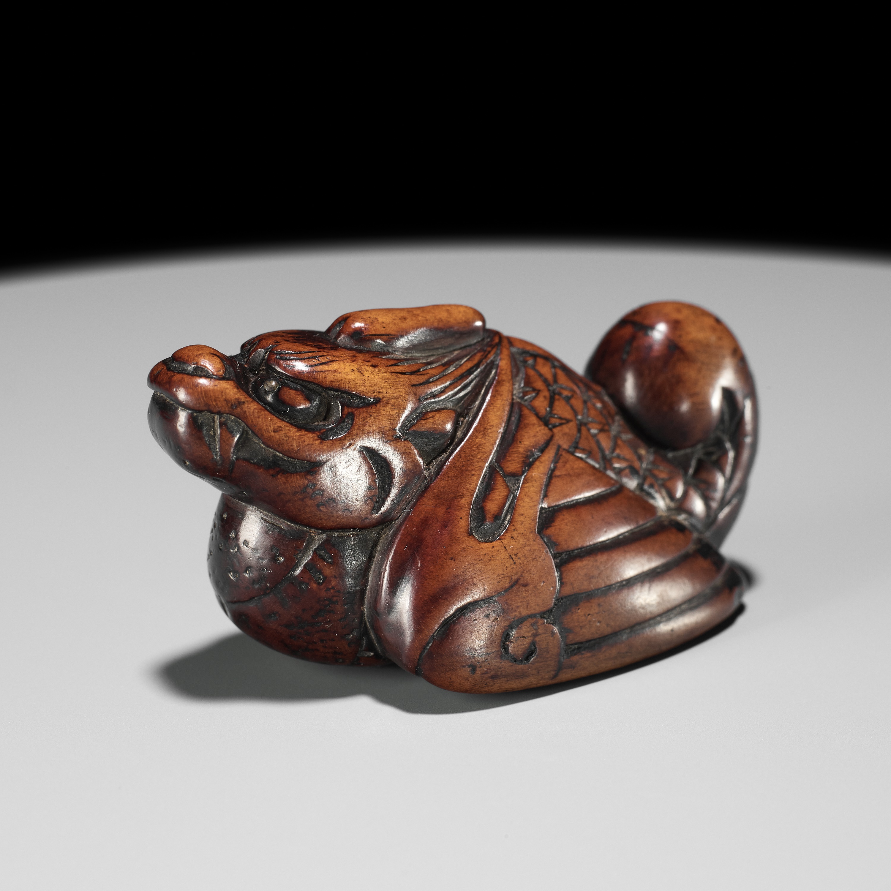 A RARE WOOD NETSUKE OF A HIRYU (FLYING DRAGON), SOKEN KISHO TYPE