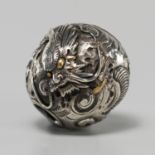 A FINE SILVER OJIME DEPICTING A FIERCE DRAGON