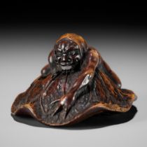 HOSHUNSAI MASAYUKI: A FINE WOOD NETSUKE OF AN ONI CATCHING A TERRAPIN