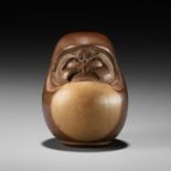 SUKEYUKI: A RARE HIDA SCHOOL ITTOBORI YEW WOOD NETSUKE OF A DARUMA DOLL