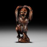 A RARE AND EARLY WOOD NETSUKE OF KOSHOHEI