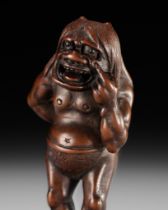 A SUPERB WOOD NETSUKE OF A MISCHIEVOUS ONI, ATTRIBUTED TO IKKYU