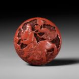 A FINE TSUISHU (CARVED RED LACQUER) MANJU NETSUKE WITH CHINESE LITERATI AND SHISHI