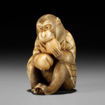 TSUNEKAZU: AN IVORY NETSUKE OF A MONKEY EATING A PEACH