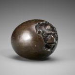 A RARE BRONZE NETSUKE OF A HATCHING TENGU (TENGU NO TOMAGO)