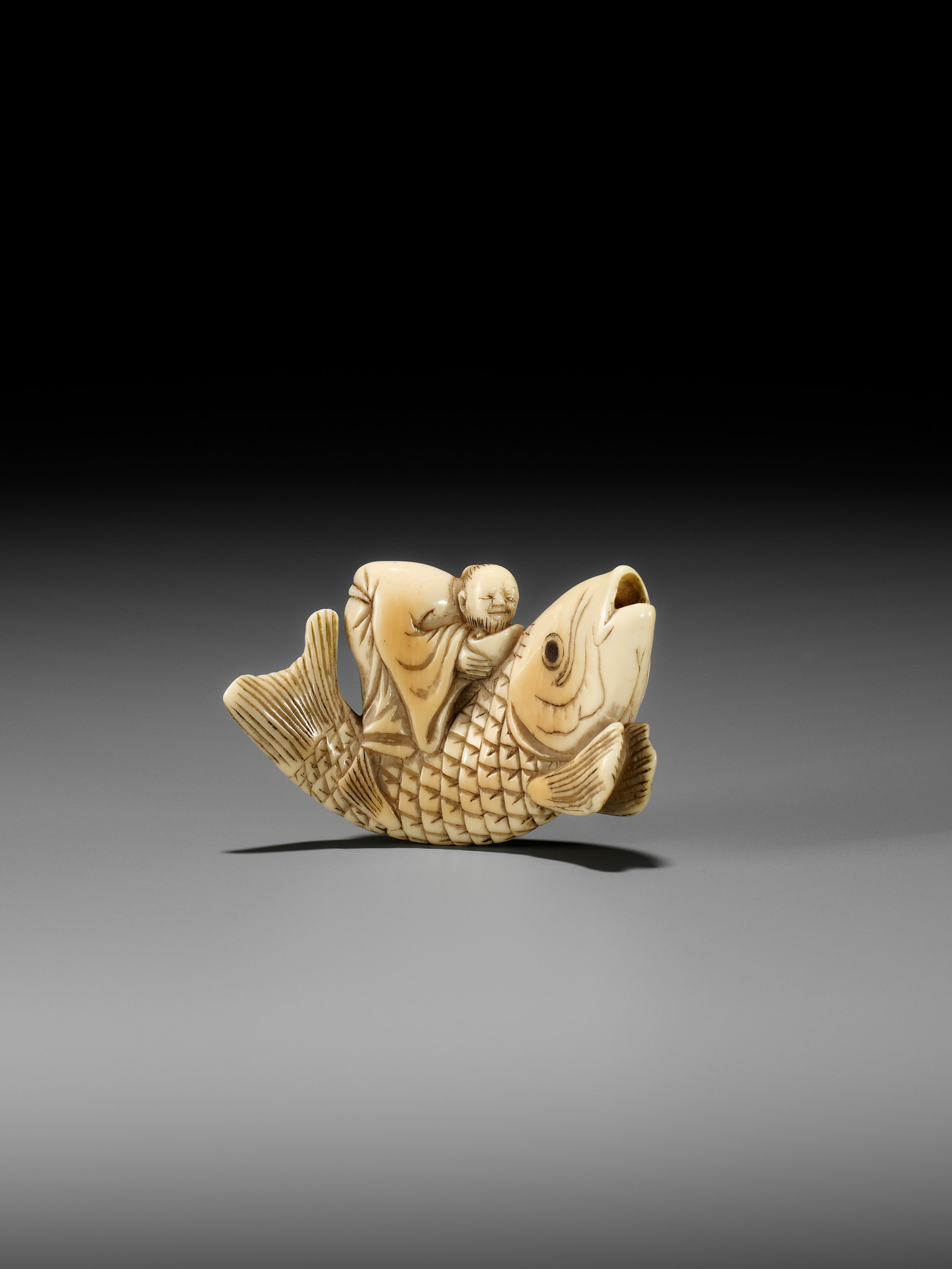 YOSHITSUGU: AN EARLY IVORY NETSUKE OF KINKO SENNIN ON A CARP - Image 3 of 14