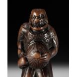 SHUGETSU I: A POWERFUL AND AMUSING WOOD NETSUKE OF AN ONI