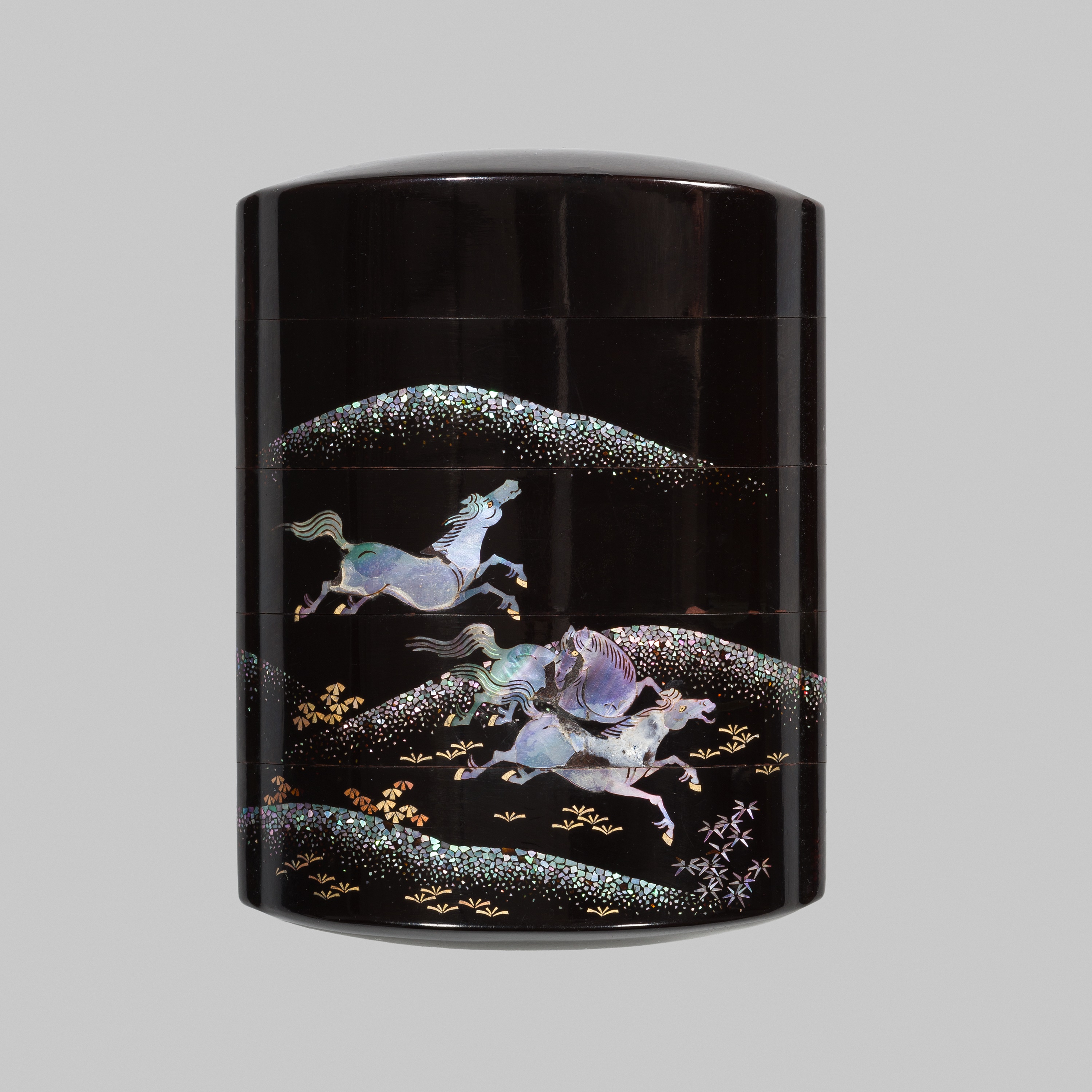 A SOMADA STYLE BLACK LACQUER FOUR-CASE INRO WITH GALLOPING HORSES