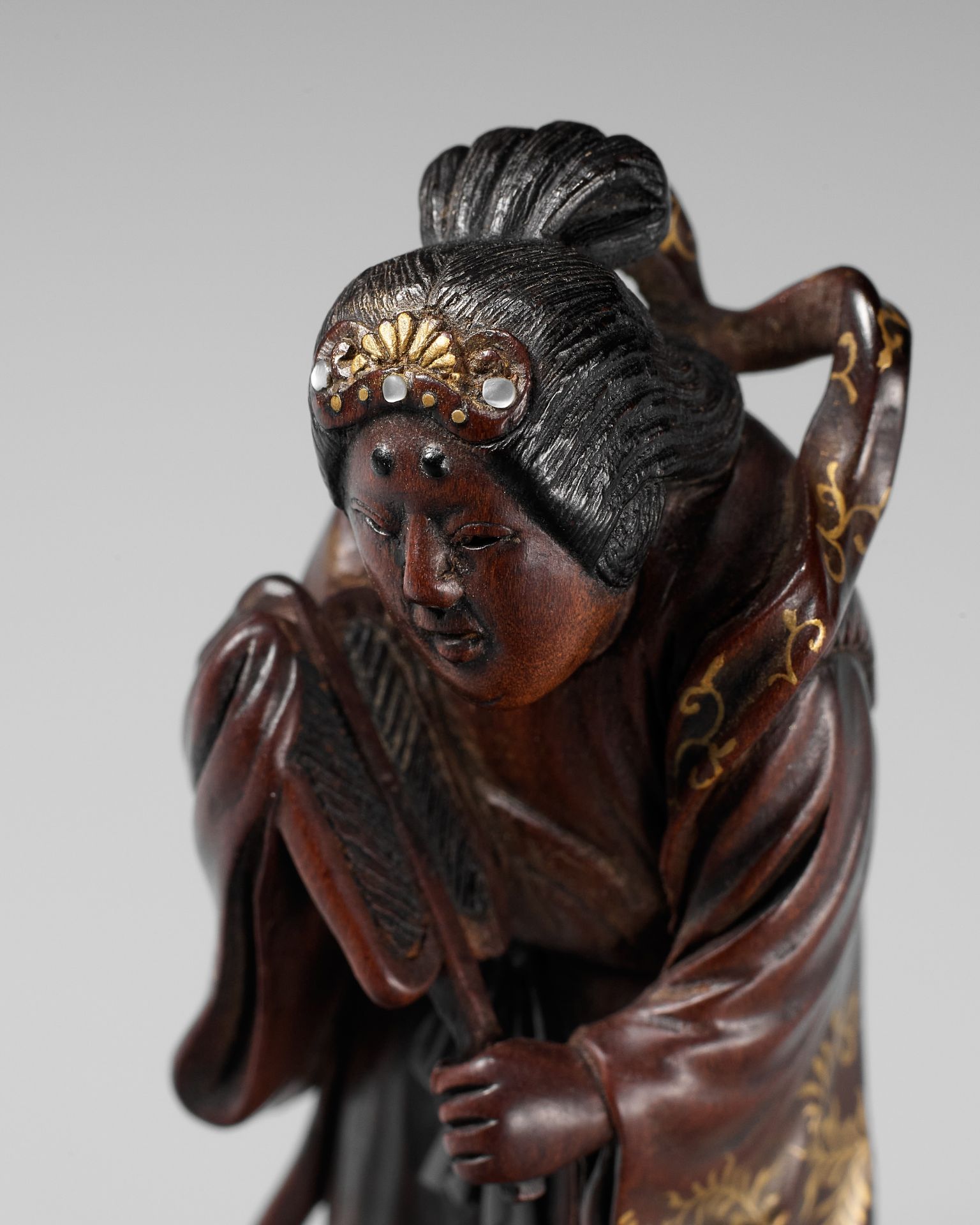 KYOKUSEI: A SUPERB AND LARGE LACQUERED AND INLAID WOOD NETSUKE OF BENTEN