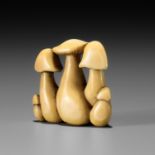 YOSHITADA: A FINE IVORY NETSUKE OF A CLUSTER OF MUSHROOMS