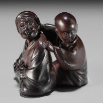 MIWA: A FINE WOOD NETSUKE OF A BLIND MASSEUR AND CLIENT