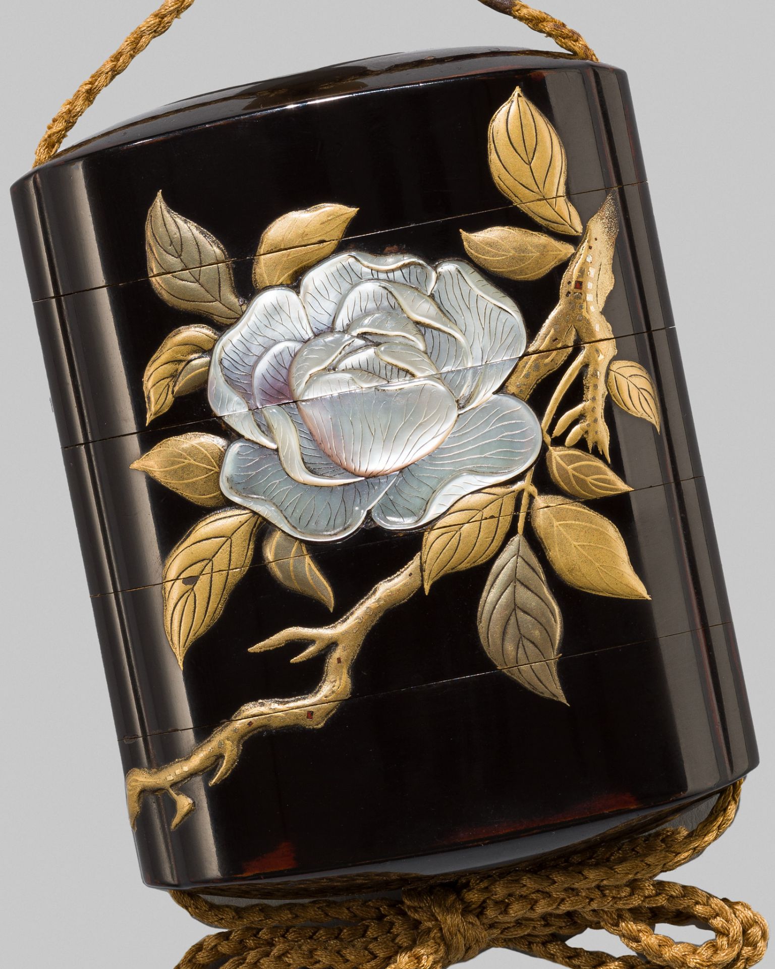 AN ELEGANT INLAID BLACK LACQUER FOUR-CASE INRO WITH CAMELLIA BLOSSOMS
