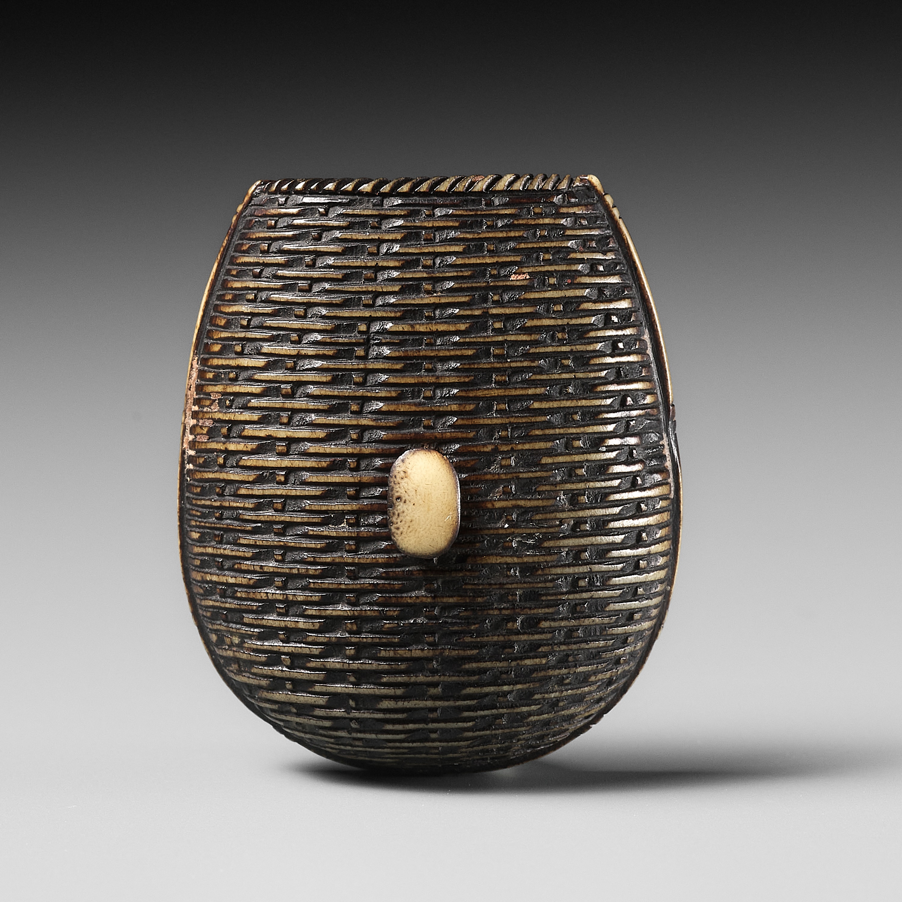 A FINE ANTLER NETSUKE OF A WINNOWING BASKET