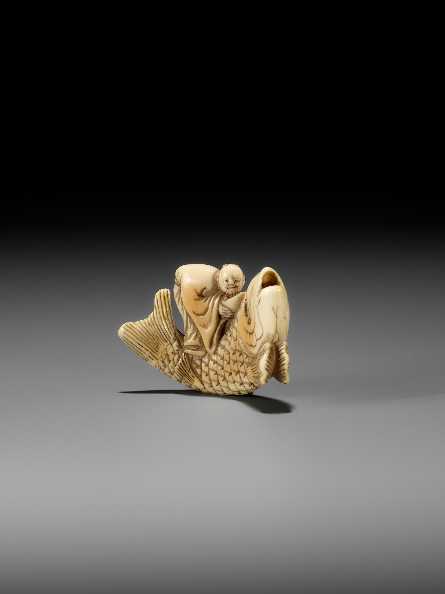 YOSHITSUGU: AN EARLY IVORY NETSUKE OF KINKO SENNIN ON A CARP - Image 9 of 14