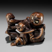 TAMEKAZU: AN AMUSING WOOD NETSUKE OF TWO FISHERMEN FIGHTING AN OCTOPUS