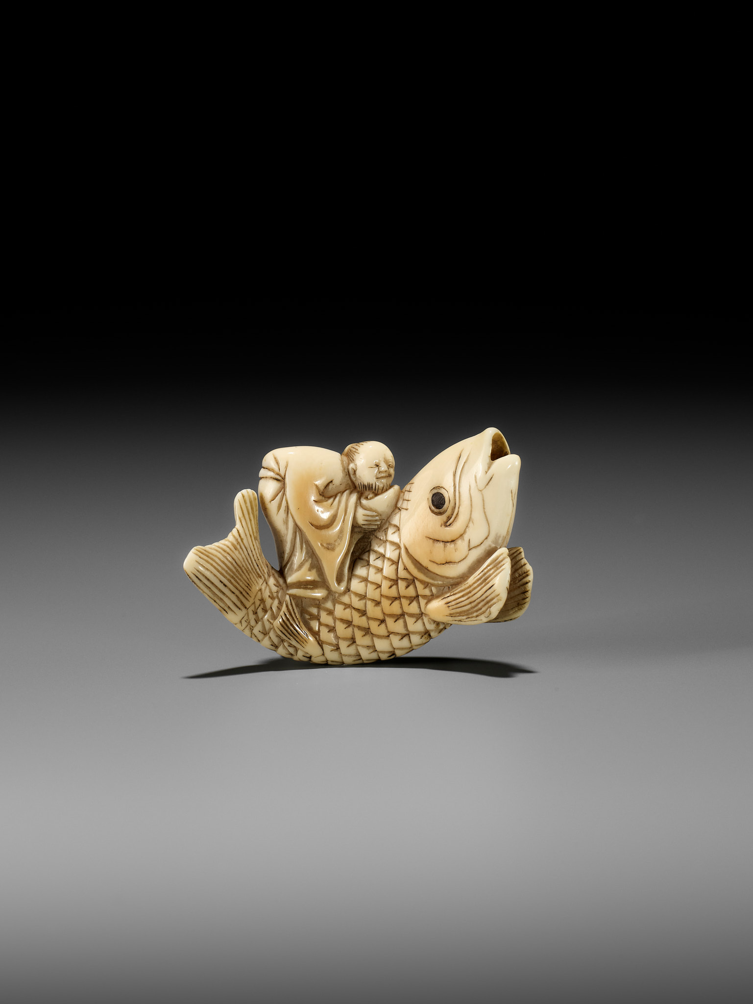 YOSHITSUGU: AN EARLY IVORY NETSUKE OF KINKO SENNIN ON A CARP - Image 7 of 14