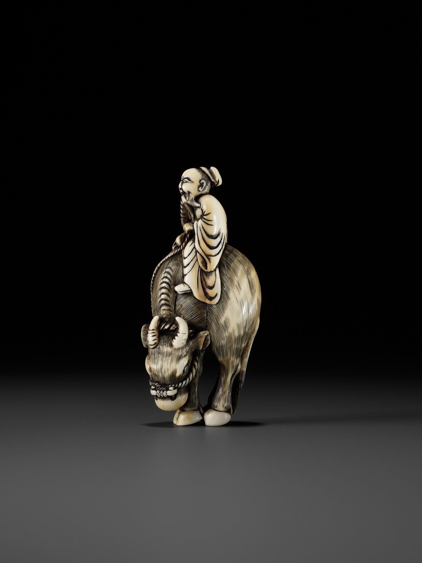 A FINE IVORY NETSUKE OF ROSHI ATOP AN OX - Image 3 of 12