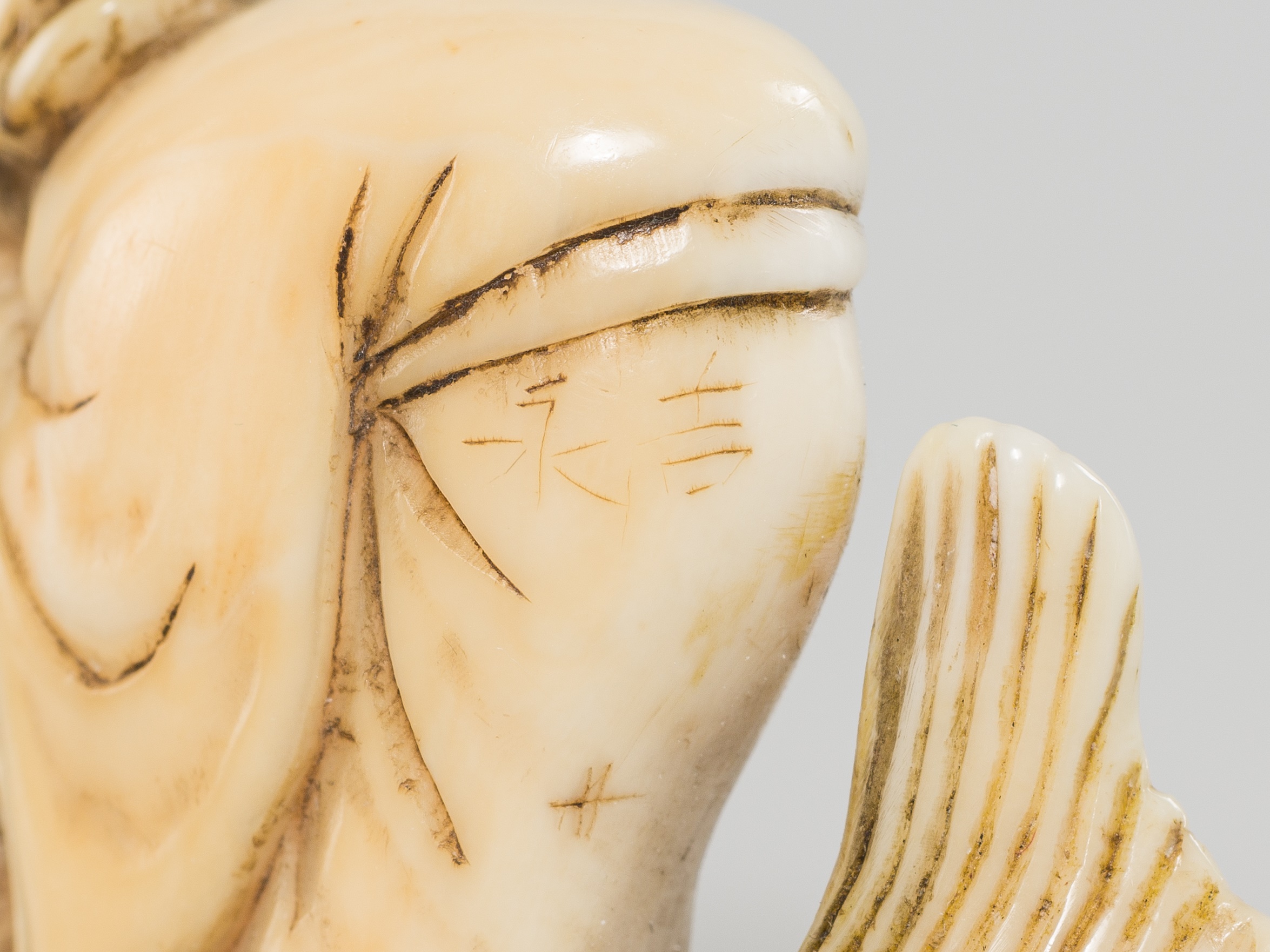 YOSHITSUGU: AN EARLY IVORY NETSUKE OF KINKO SENNIN ON A CARP - Image 13 of 14