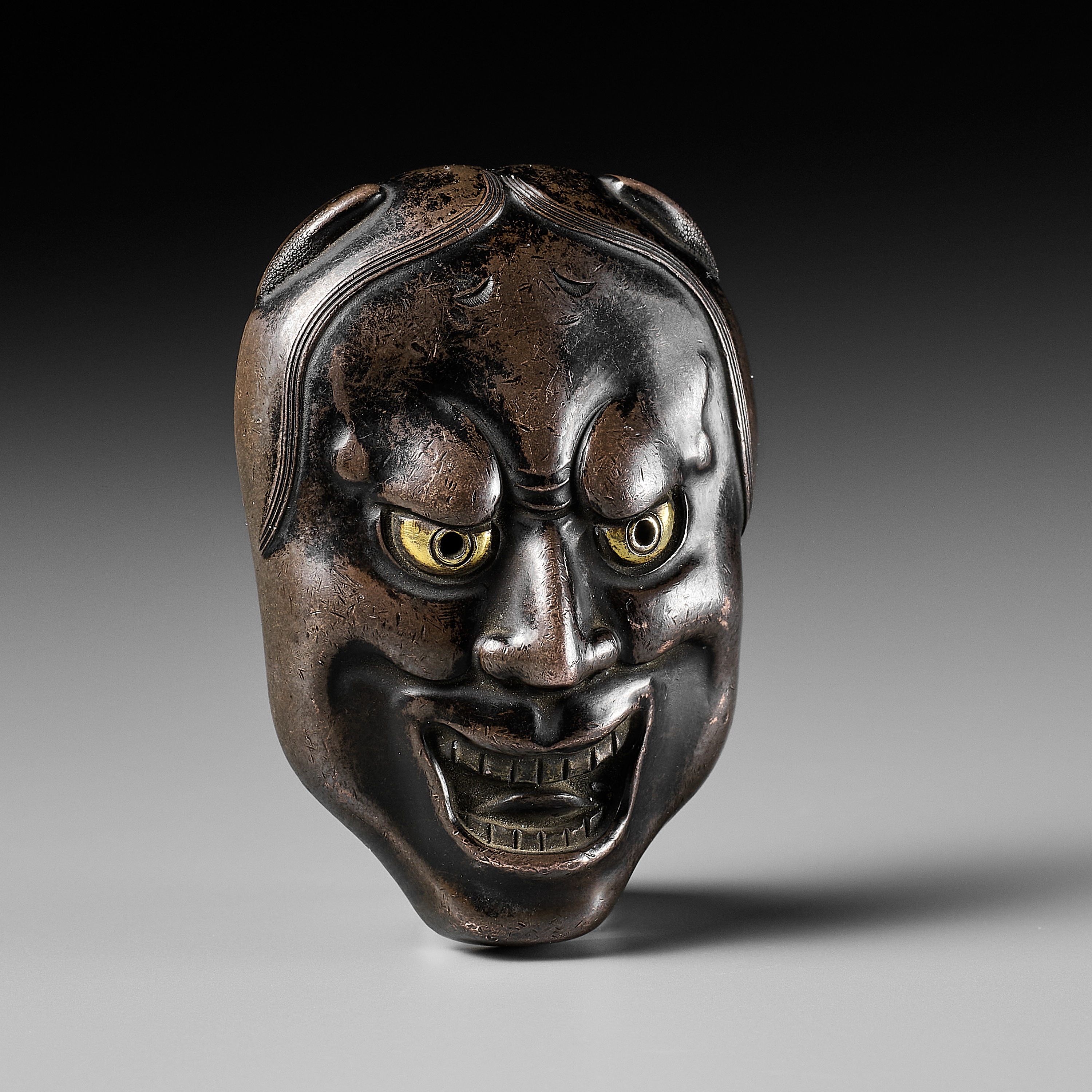 KATSURA NOBUHARU: A FINE AND RARE BRONZE MASK NETSUKE OF HANNYA