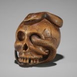 SUKEYUKI: A MASTERFUL WOOD NETSUKE OF A SNAKE AND SKULL