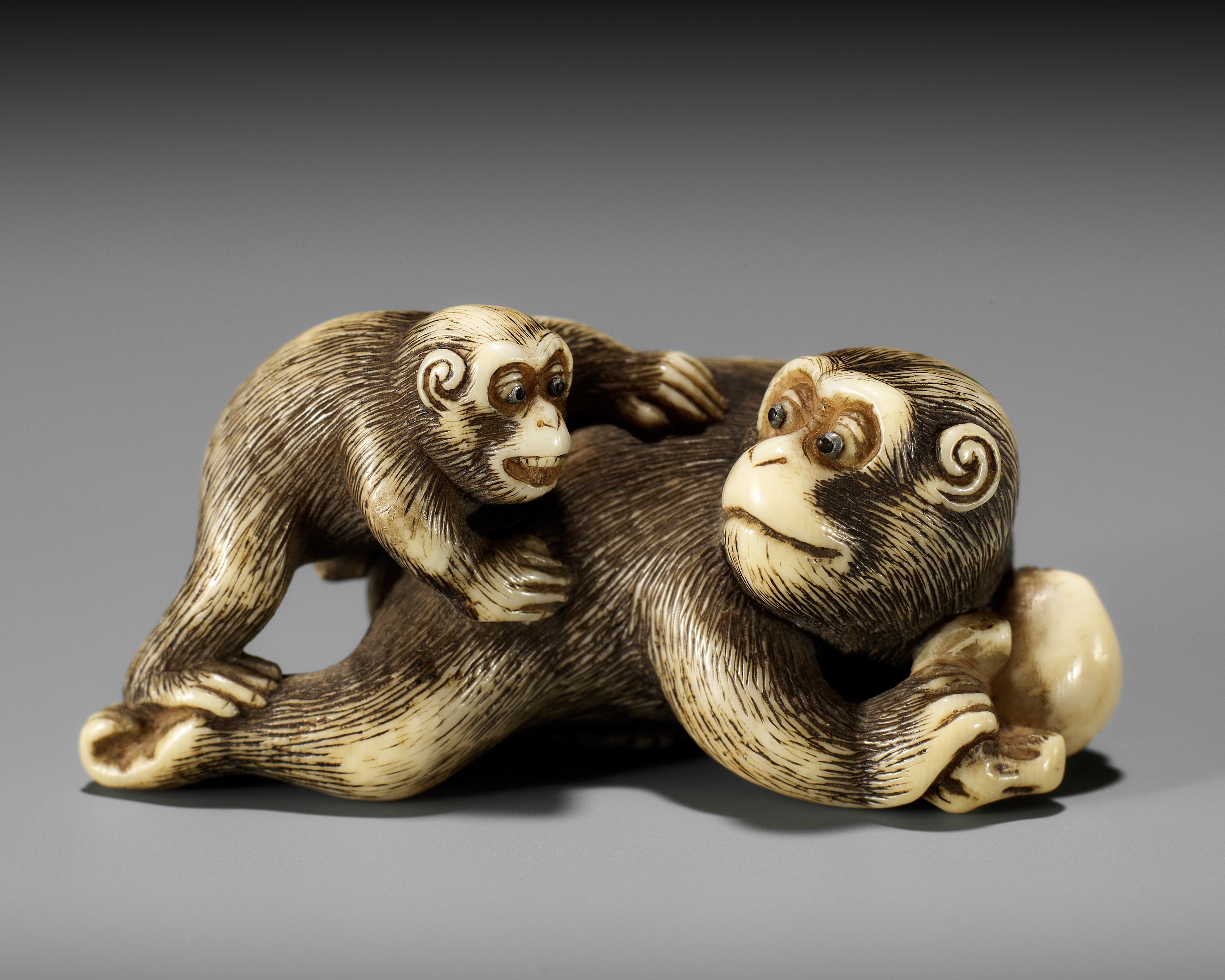 GARAKU: AN IVORY NETSUKE OF A MONKEY WITH YOUNG