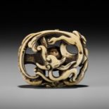 A FINE ANTLER NETSUKE OF A RAIN DRAGON ON A KONGO (VAJRA)