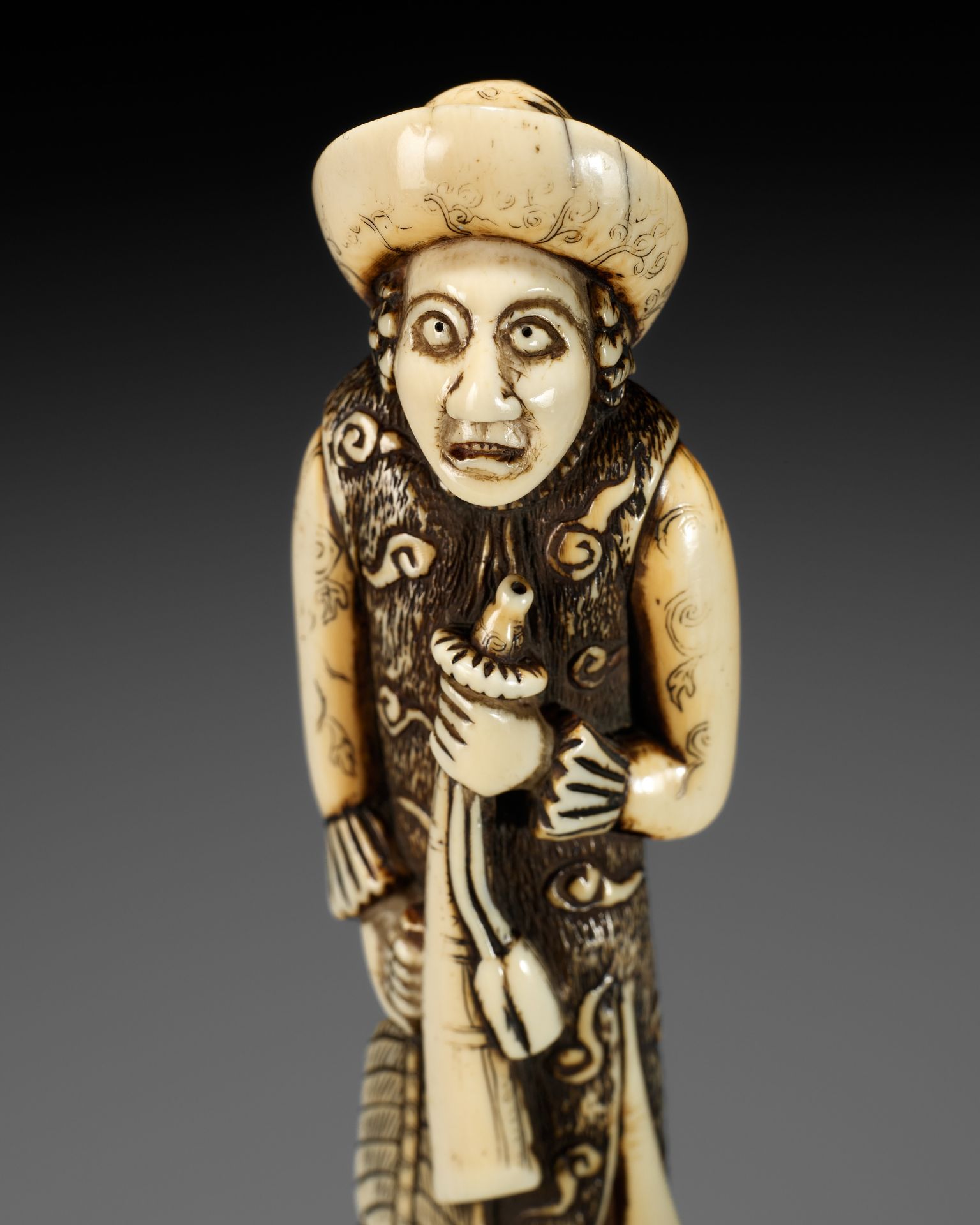 A SUPERB AND LARGE IVORY NETSUKE OF A DUTCHMAN WITH A TRUMPET