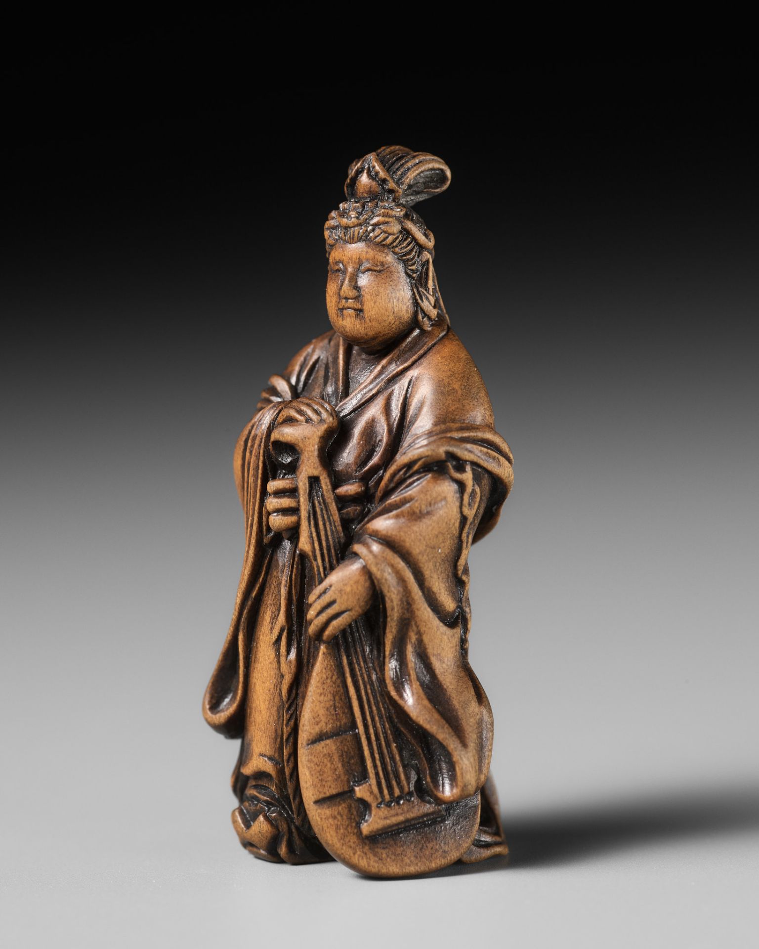 SETTEI: A VERY FINE MINIATURE WOOD NETSUKE OF BENTEN HOLDING A BIWA