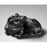 TATEKAWA KOSAI: AN EBONY WOOD NETSUKE OF A RECUMBENT OX