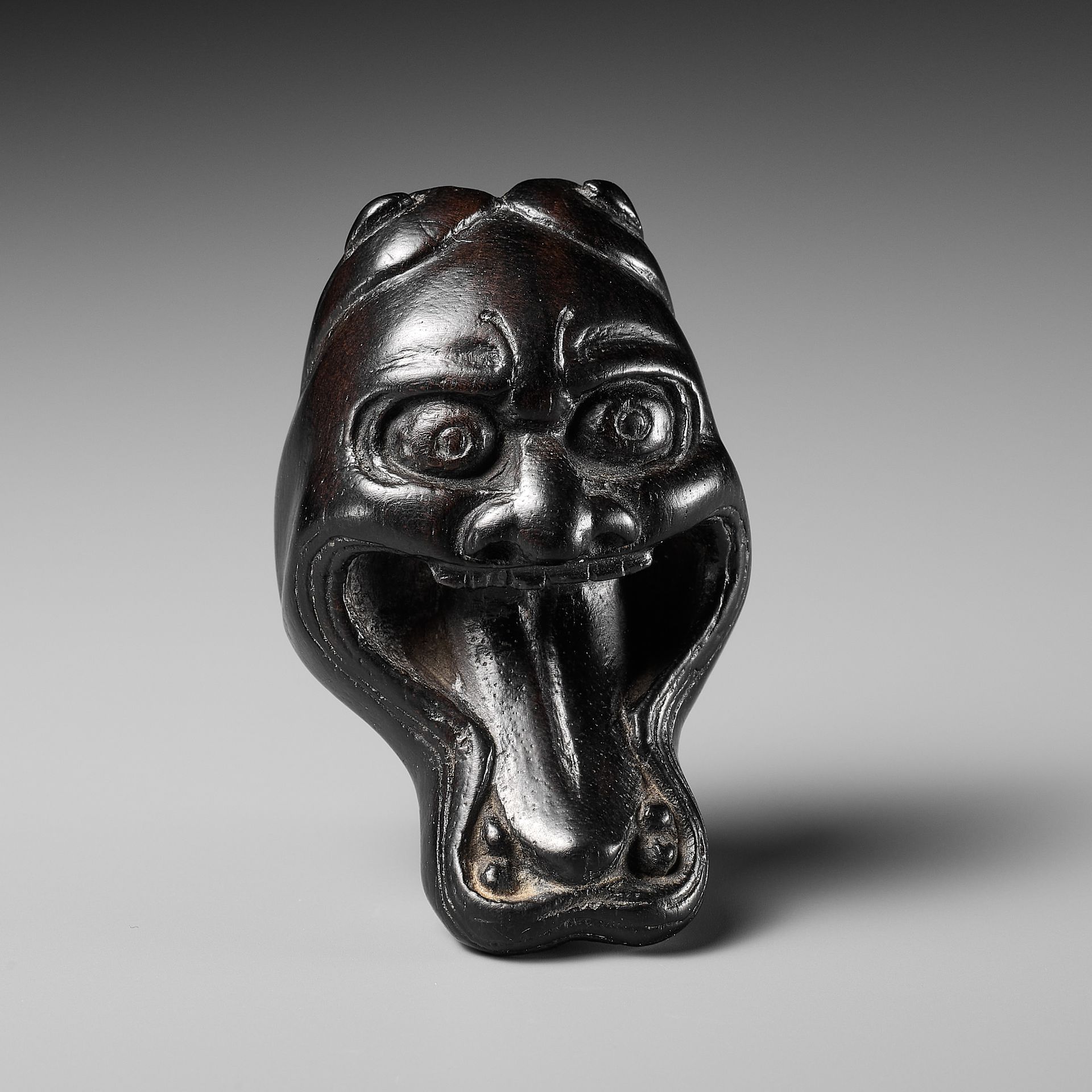 A LARGE AND UNUSUAL EBONY WOOD MASK NETSUKE OF HANNYA