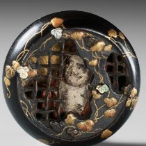 TEIJI: A MASTERFUL LACQUERED AND CERAMIC-INLAID MANJU OF DARUMA BEHIND IRON BARS