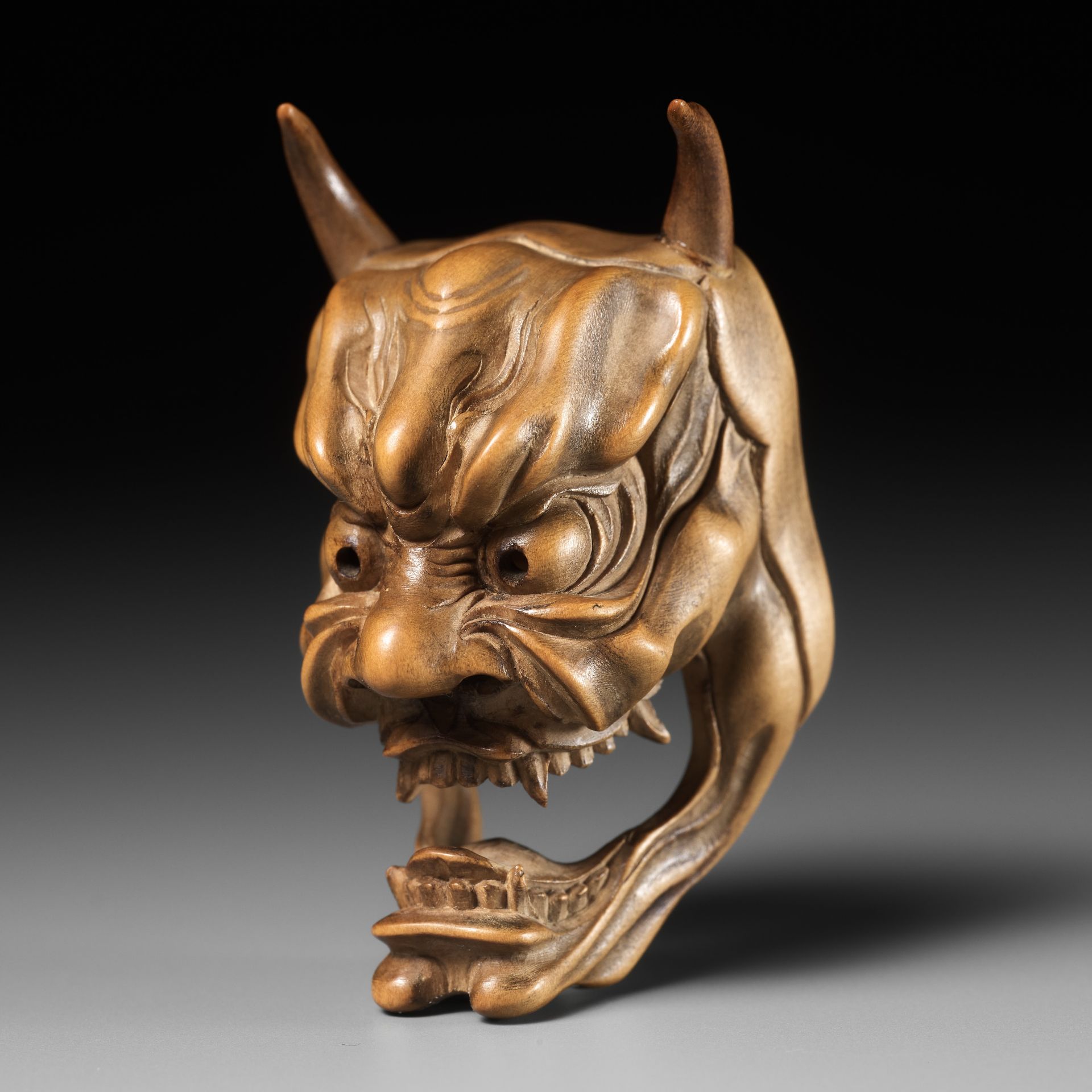 KOKEISAI SANSHO: A SUPERB PALE BOXWOOD MASK NETSUKE OF HANNYA