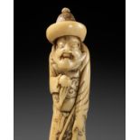 A POWERFUL ANTLER NETSUKE OF A TARTAR ARCHER