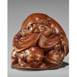 OTOMAN: A MASTERFUL WOOD NETSUKE OF HOTEI WITH TWO CHILDREN