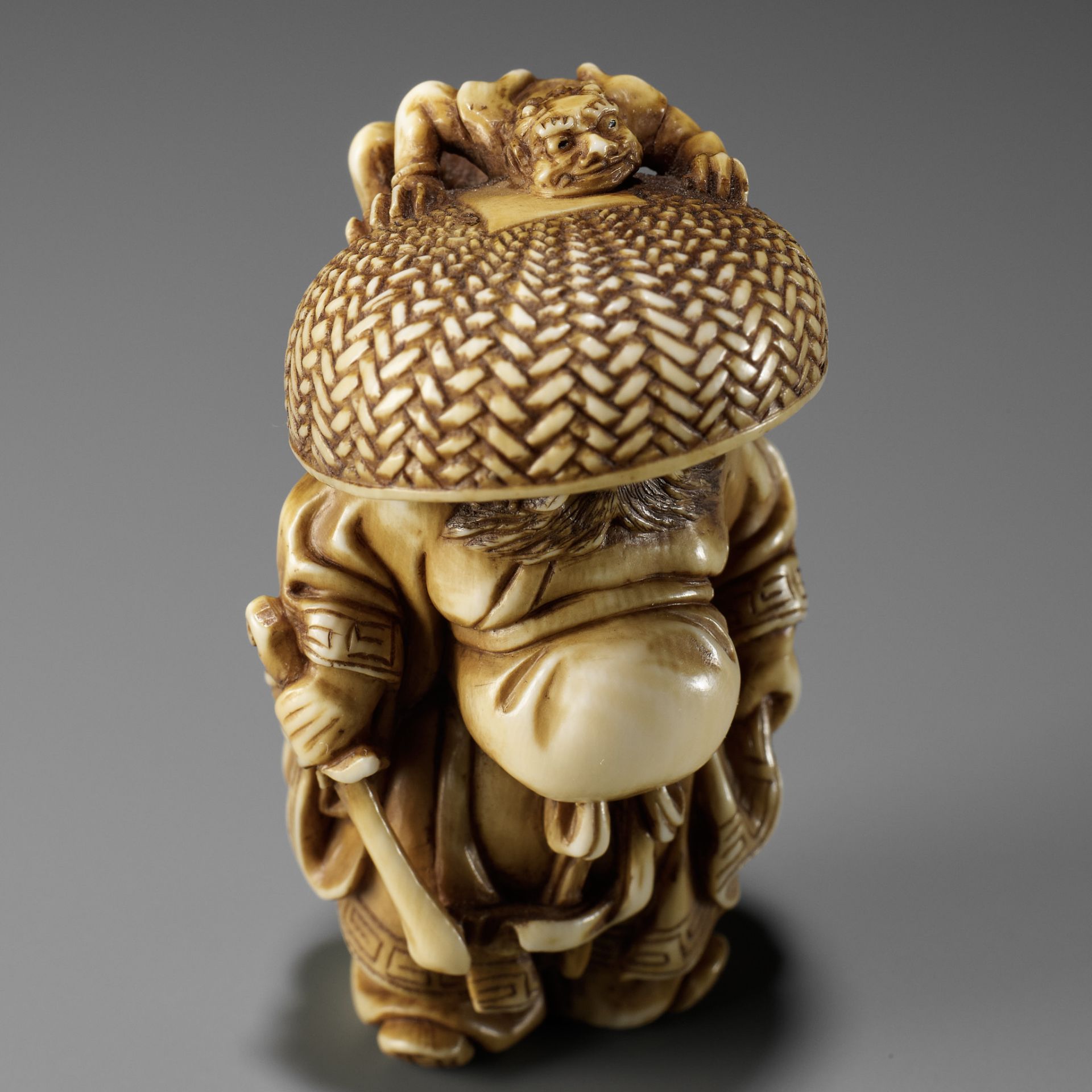 MITSUTOSHI: AN AMUSING IVORY NETSUKE OF SHOKI AND ONI