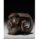 A VERY RARE SHUNGA WOOD NETSUKE OF A NAKED WOMAN AND GIANT SNAKE