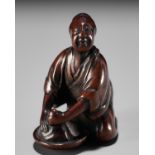 MINKOKU II: A FINE WOOD NETSUKE OF A WASHER WOMAN