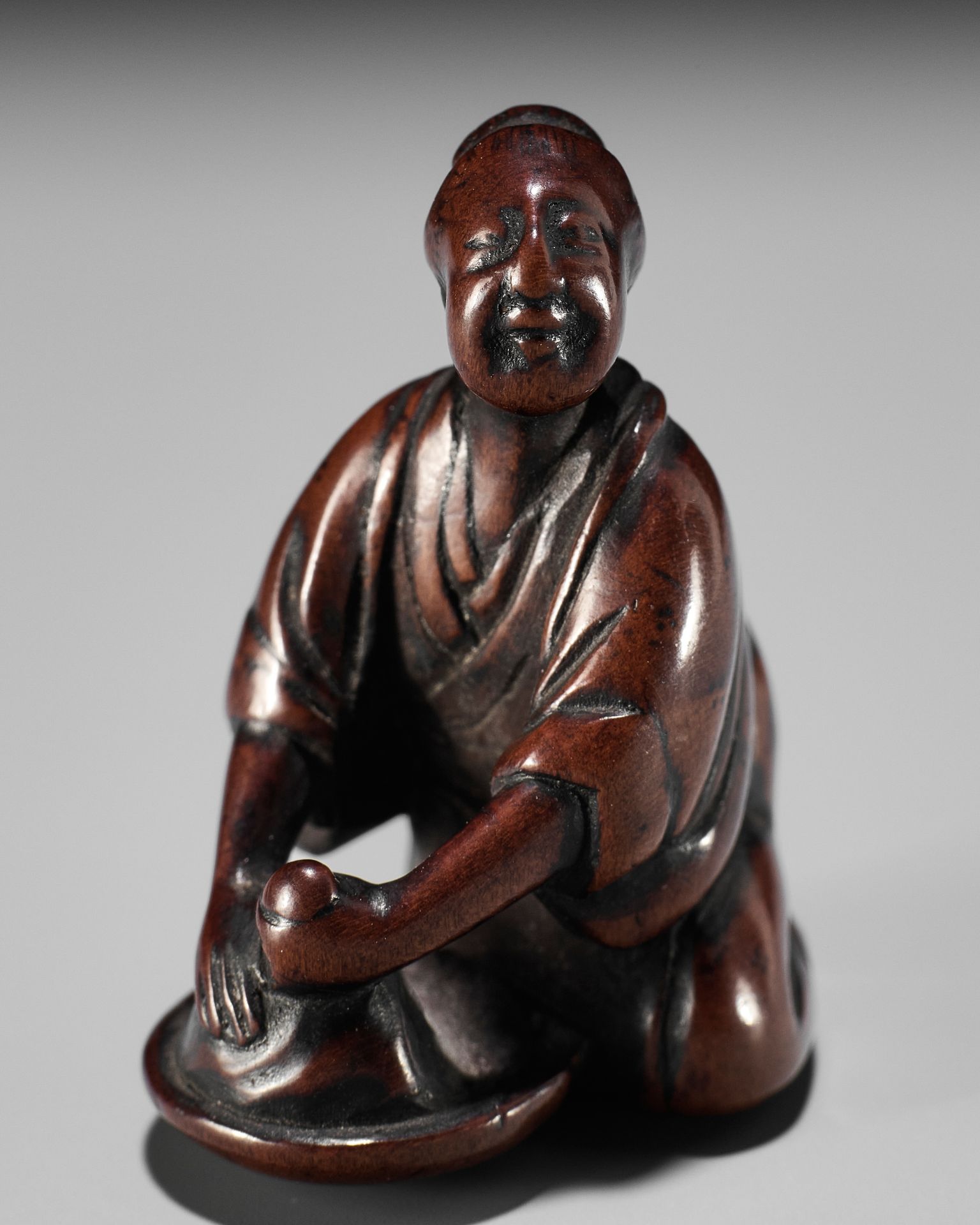 MINKOKU II: A FINE WOOD NETSUKE OF A WASHER WOMAN